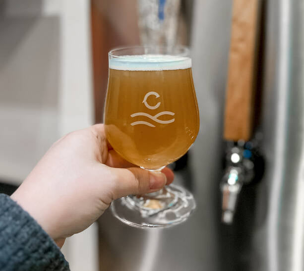Holding a beer in a Kitchener Brewery Taproom